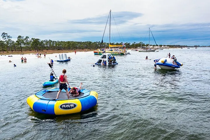 Guests on the inflatable water park and catamaran off Shell Island on a Shell Island dolphin tour from Panama City Beach